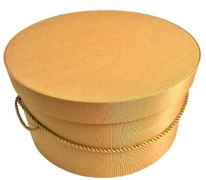 172-A deep rich gold bengaline fabric hatbox with a gold cording handle.